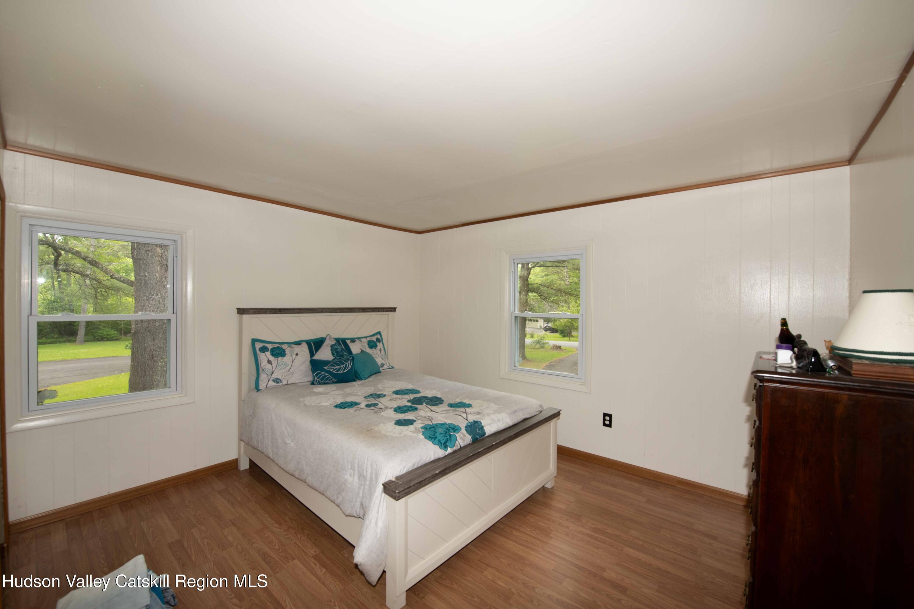 22 Elm Lane Greenville, NY 12083 - Photo 11 of 19 a white bed sitting in a bedroom next to a window