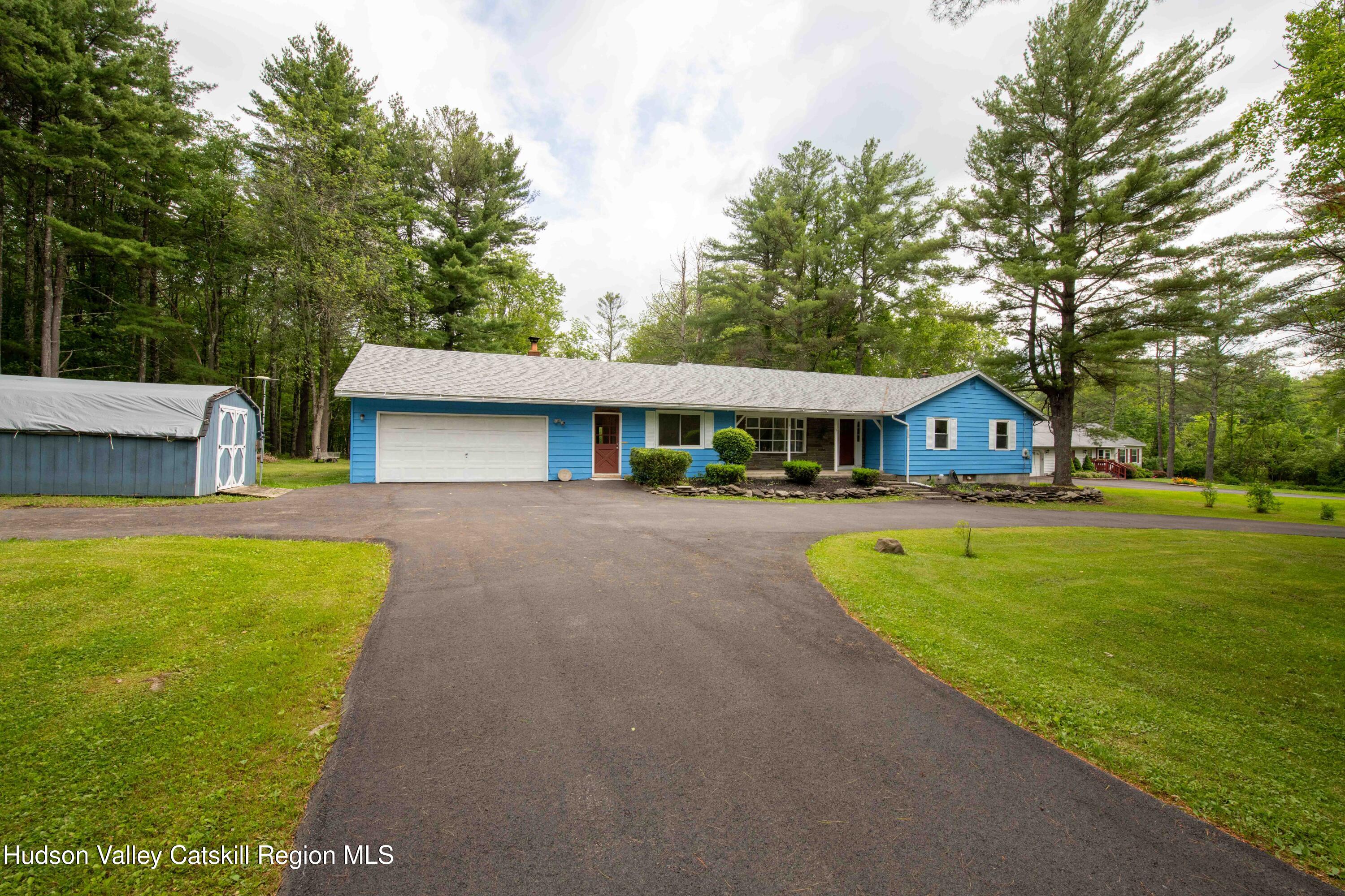 22 Elm Lane Greenville, NY 12083 - Photo 18 of 19 a front view of a house with a yard table and trees