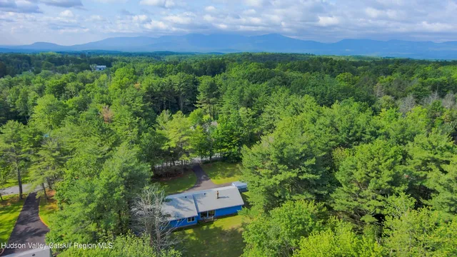 an aerial view of a house with a yard