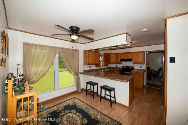 a open kitchen with stainless steel appliances granite countertop a stove and a refrigerator