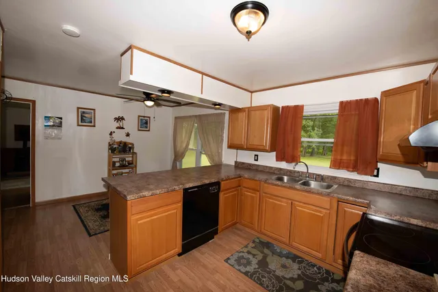 a kitchen with stainless steel appliances granite countertop a sink and a stove