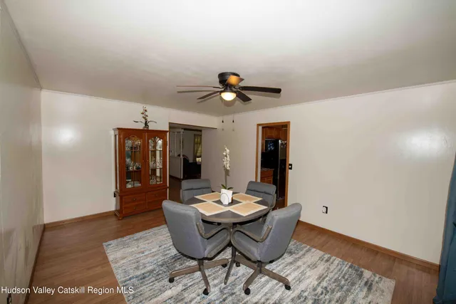 a living room with furniture and view of kitchen