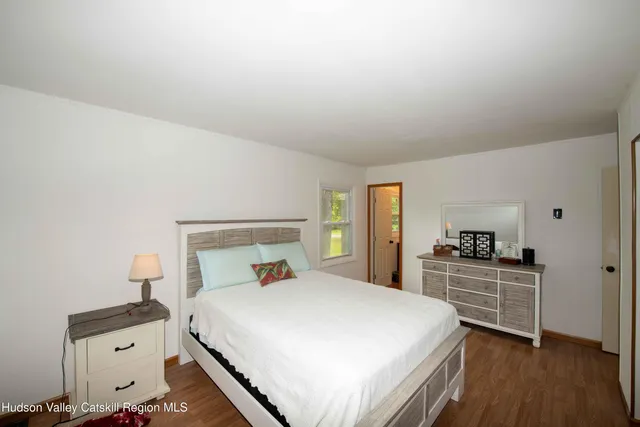 a bedroom with a bed and a dresser