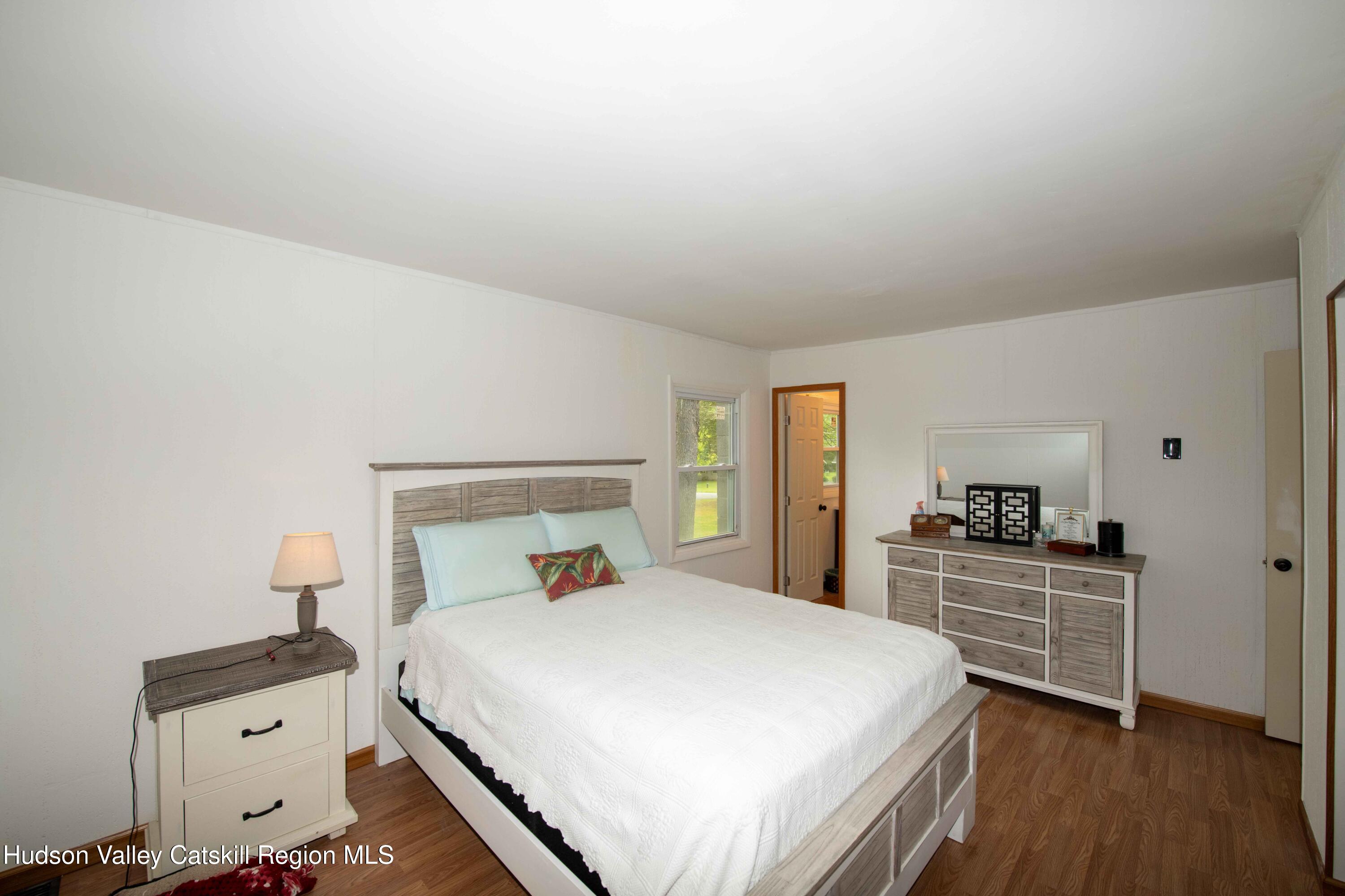 22 Elm Lane Greenville, NY 12083 - Photo 8 of 19 a bedroom with a bed and a dresser