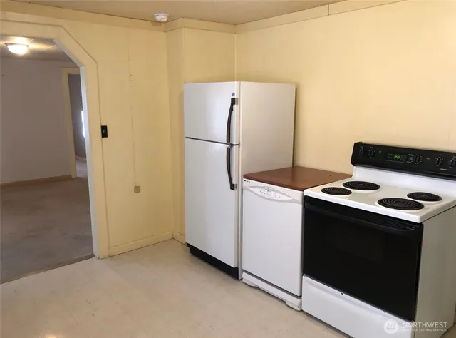a kitchen with a stove and a refrigerator