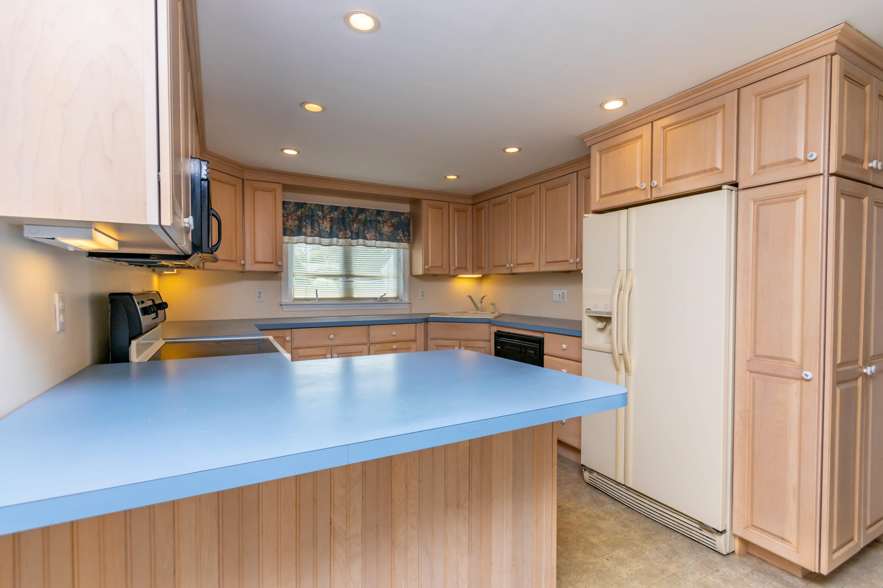 57 Puritan Road Buzzards Bay, MA 02532 - Photo 6 of 27 a kitchen with stainless steel appliances a refrigerator sink and cabinets