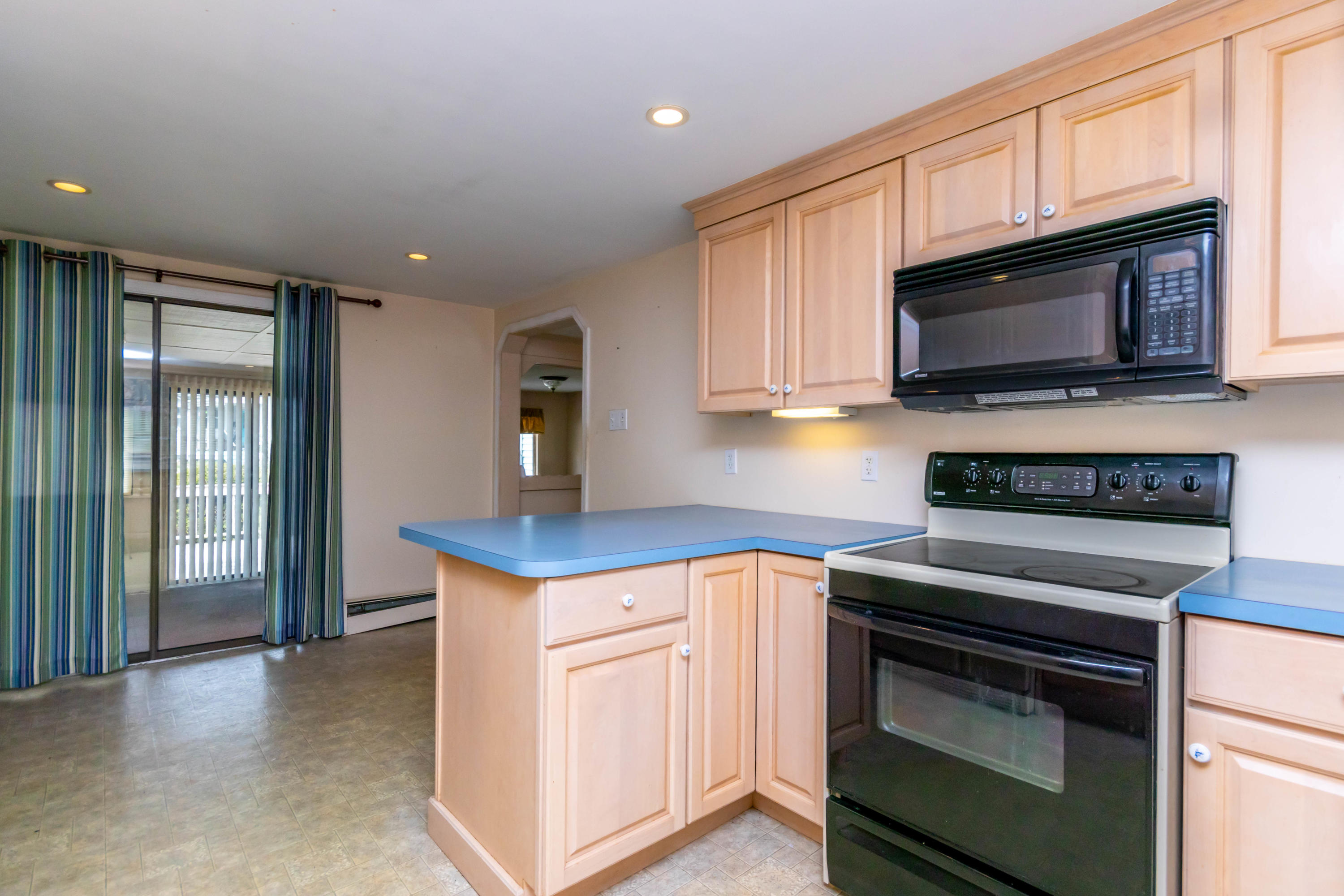 57 Puritan Road Buzzards Bay, MA 02532 - Photo 8 of 27 a kitchen with stainless steel appliances granite countertop a stove microwave and sink