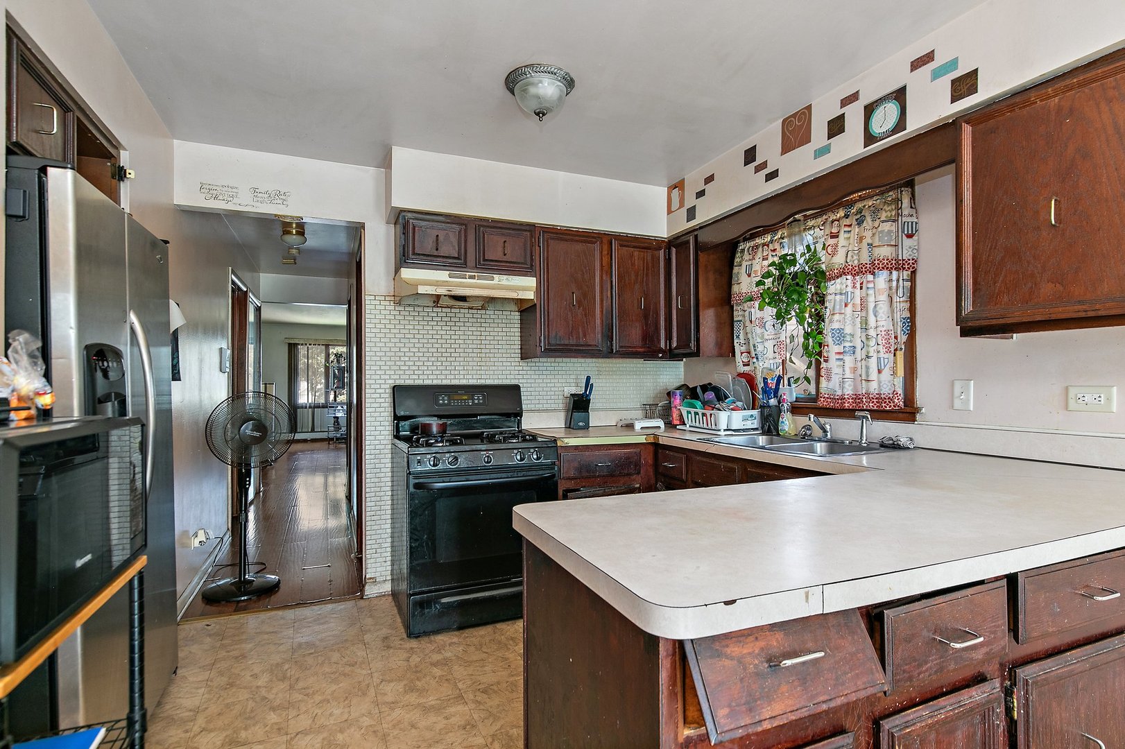 1955 Vermont Avenue Blue Island, IL 60406 - Photo 16 of 34 a kitchen with a stove a sink and a refrigerator