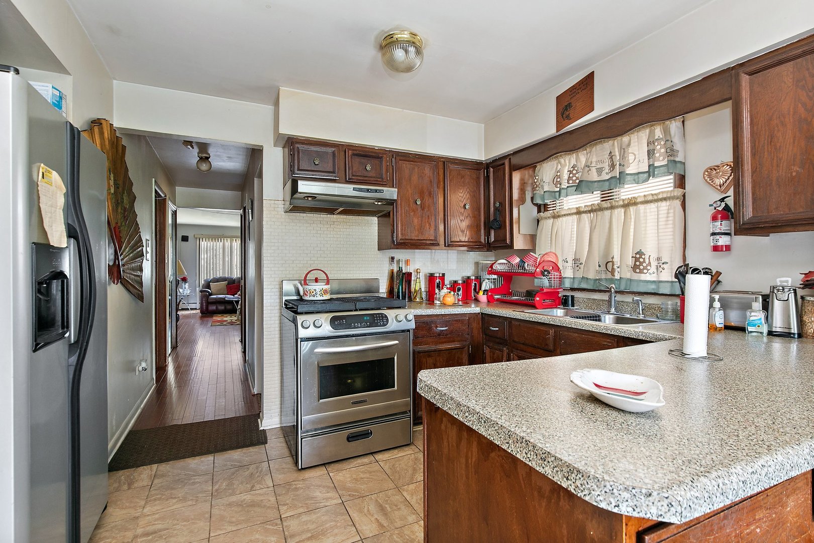 1955 Vermont Avenue Blue Island, IL 60406 - Photo 4 of 34 a kitchen with stainless steel appliances granite countertop a sink and a refrigerator
