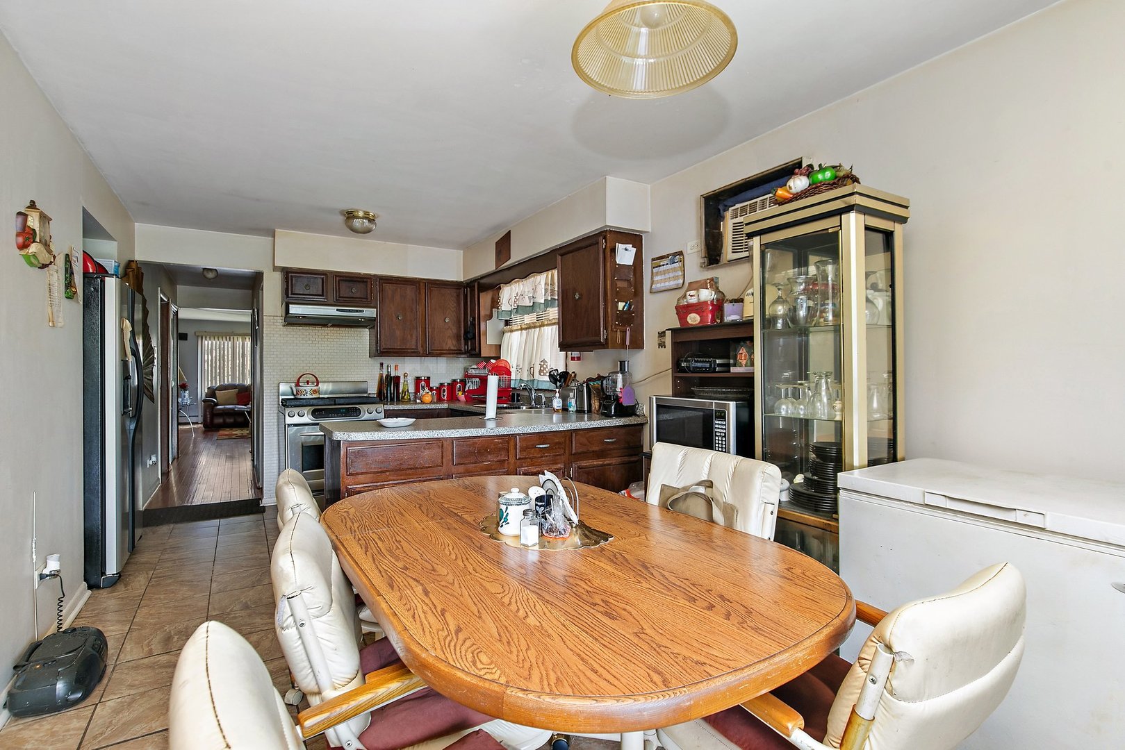 1955 Vermont Avenue Blue Island, IL 60406 - Photo 7 of 34 a living room with stainless steel appliances furniture a rug and a kitchen view