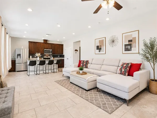 a living room with furniture and kitchen view