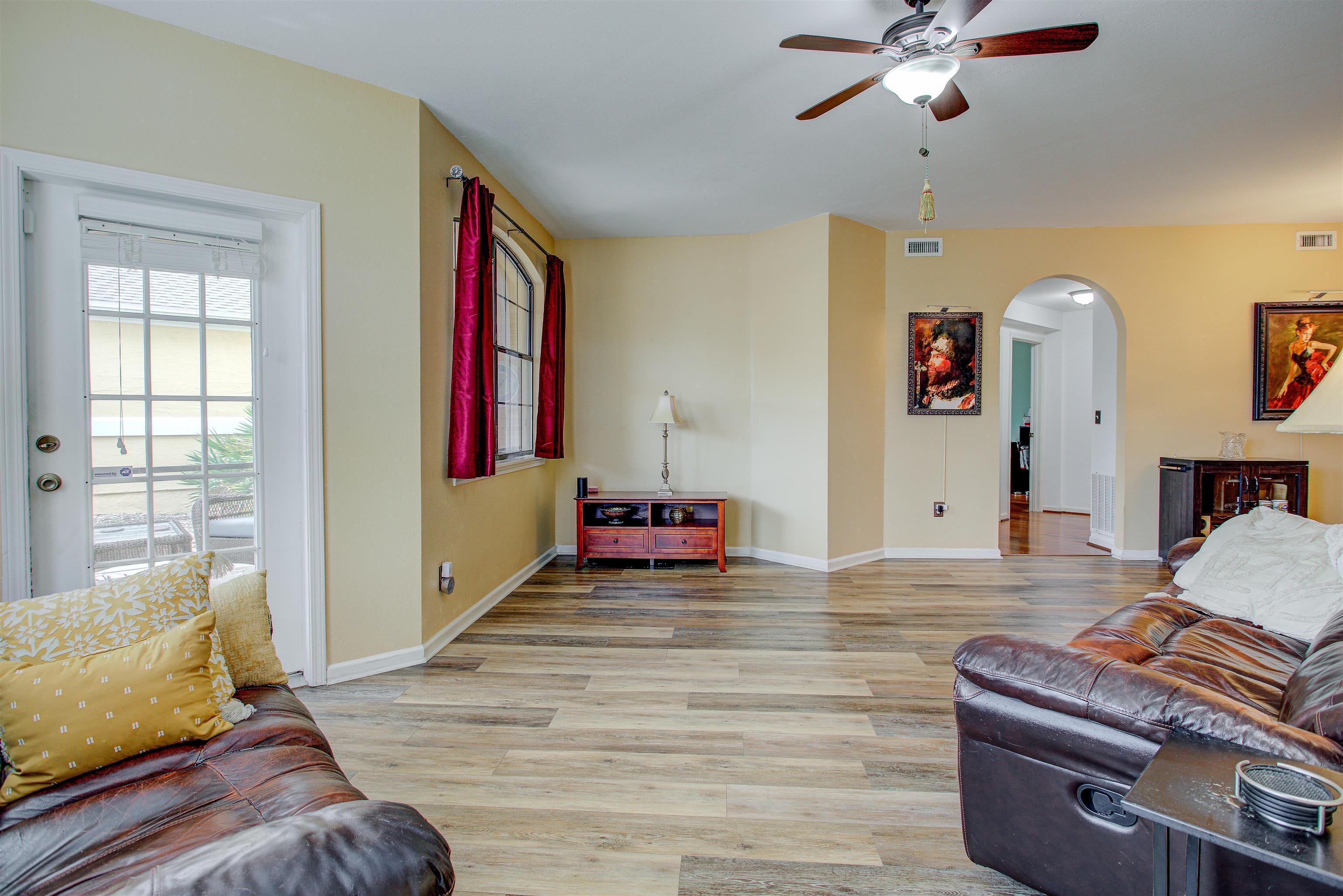 1800 Vista Cove Road St. Augustine, FL 32084 - Photo 13 of 69 Living room featuring light wood finished floors, a ceiling fan, and arched walkways