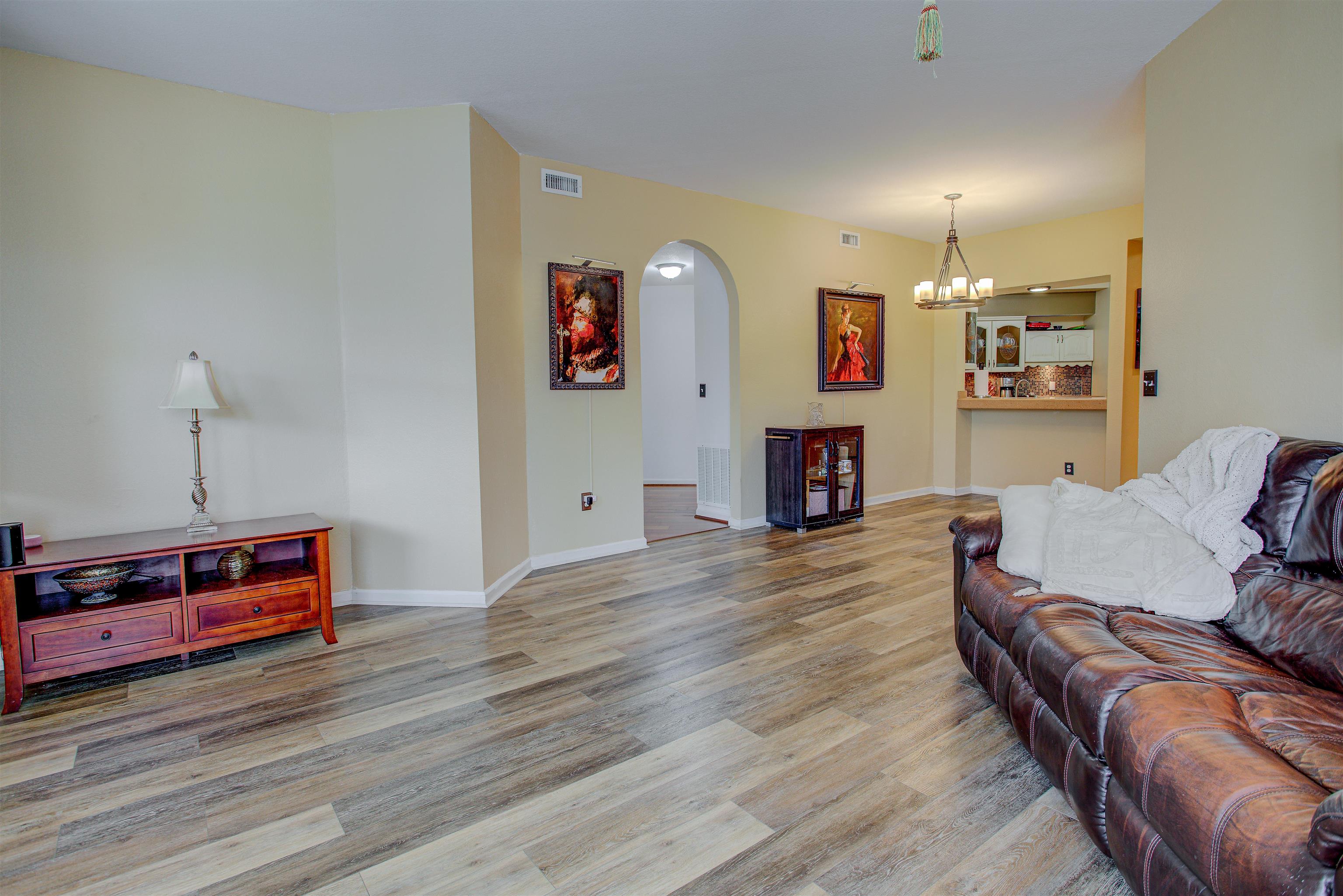 1800 Vista Cove Road St. Augustine, FL 32084 - Photo 15 of 69 Living room with light wood-type flooring, arched walkways, and suspended lighting
