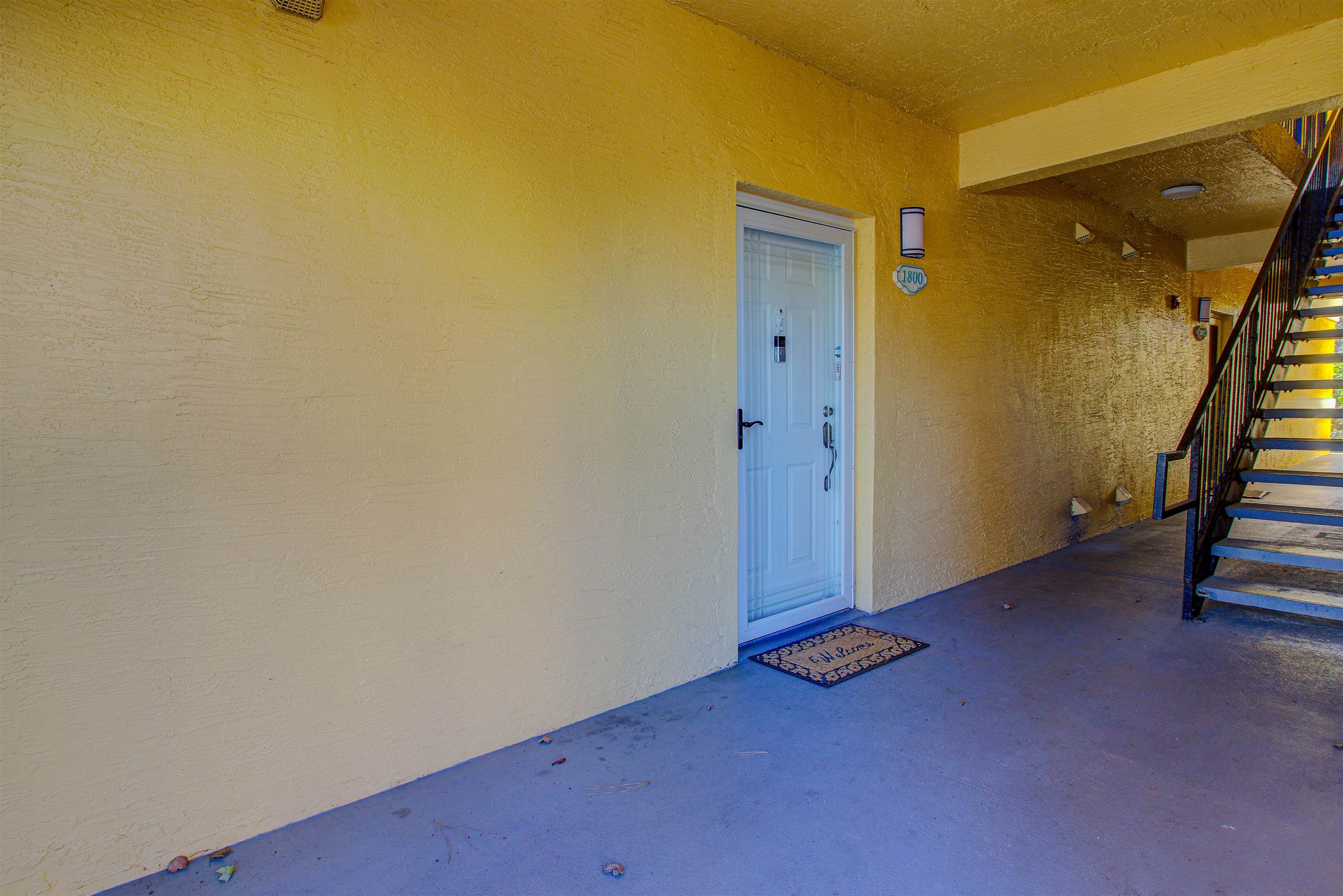 1800 Vista Cove Road St. Augustine, FL 32084 - Photo 16 of 58 View of exterior entry with stucco siding and a patio