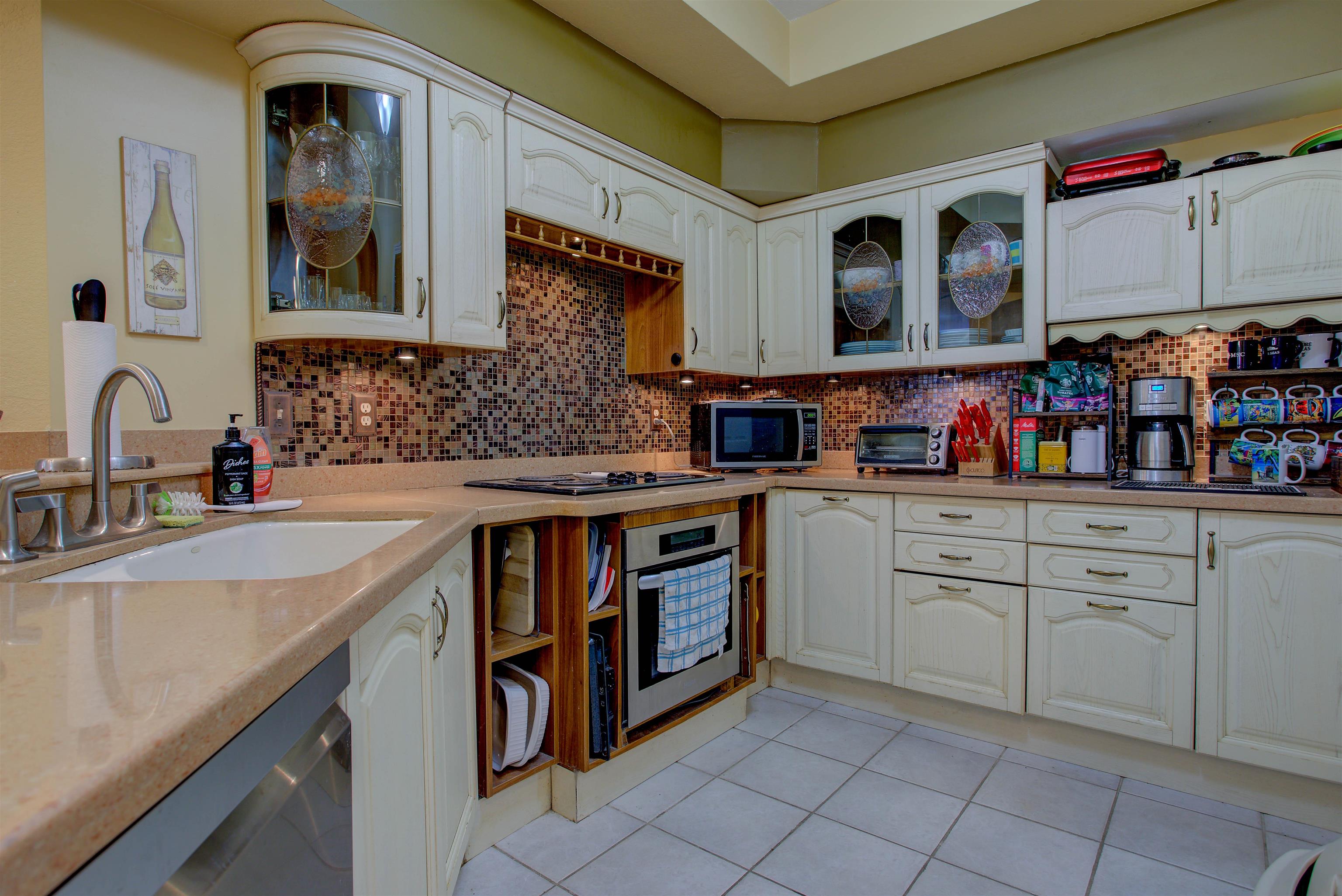 1800 Vista Cove Road St. Augustine, FL 32084 - Photo 18 of 58 a kitchen with stainless steel appliances granite countertop a sink and cabinets