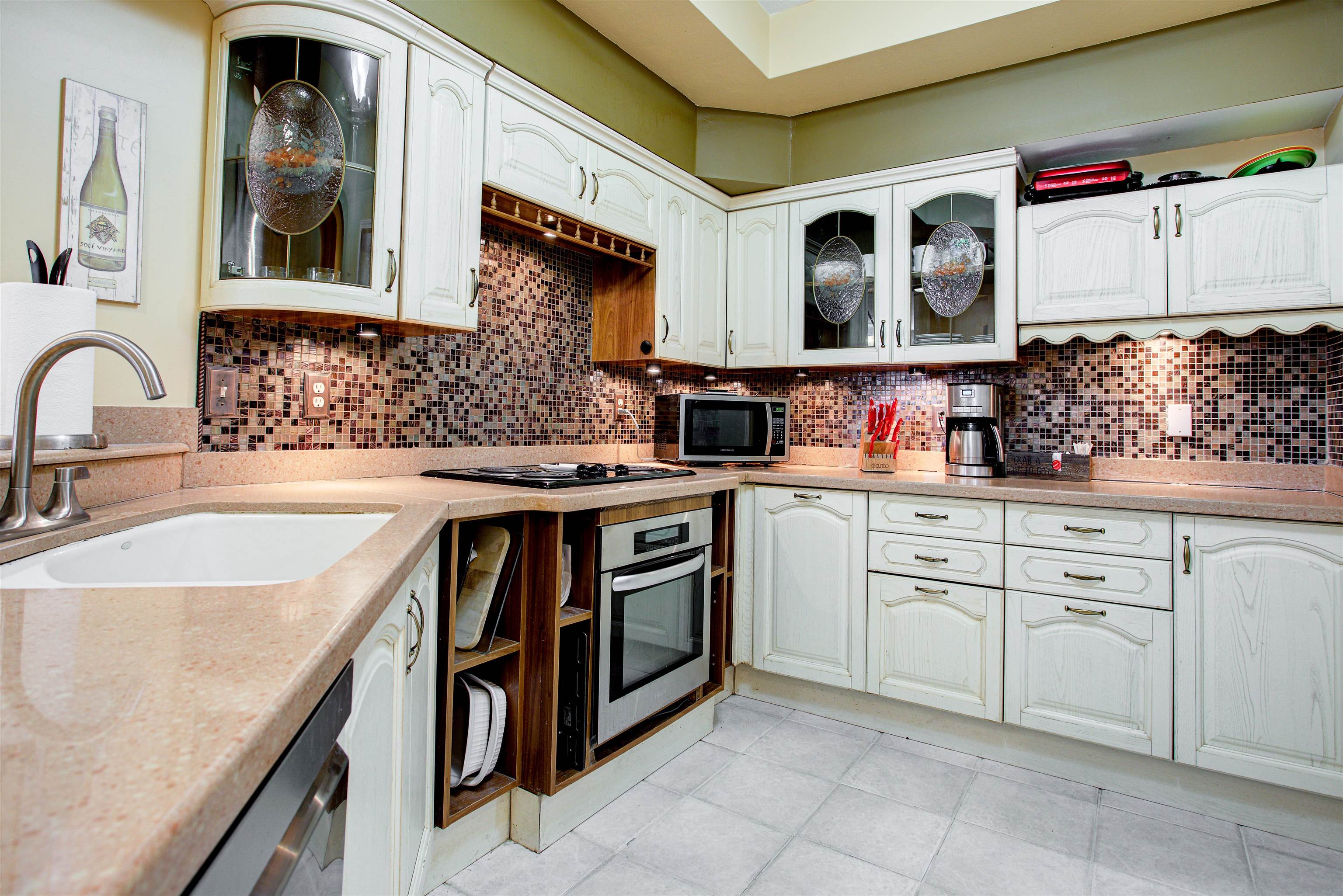 1800 Vista Cove Road St. Augustine, FL 32084 - Photo 19 of 69 Kitchen featuring glass insert cabinets, stainless steel appliances, white cabinetry, and light stone counters
