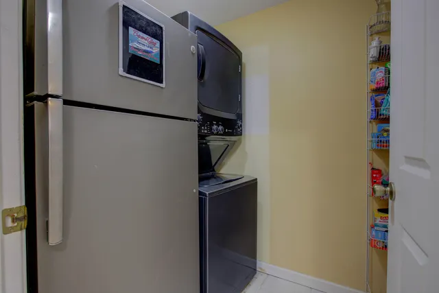 a dining room with wooden floor a chandelier a wooden table and chairs