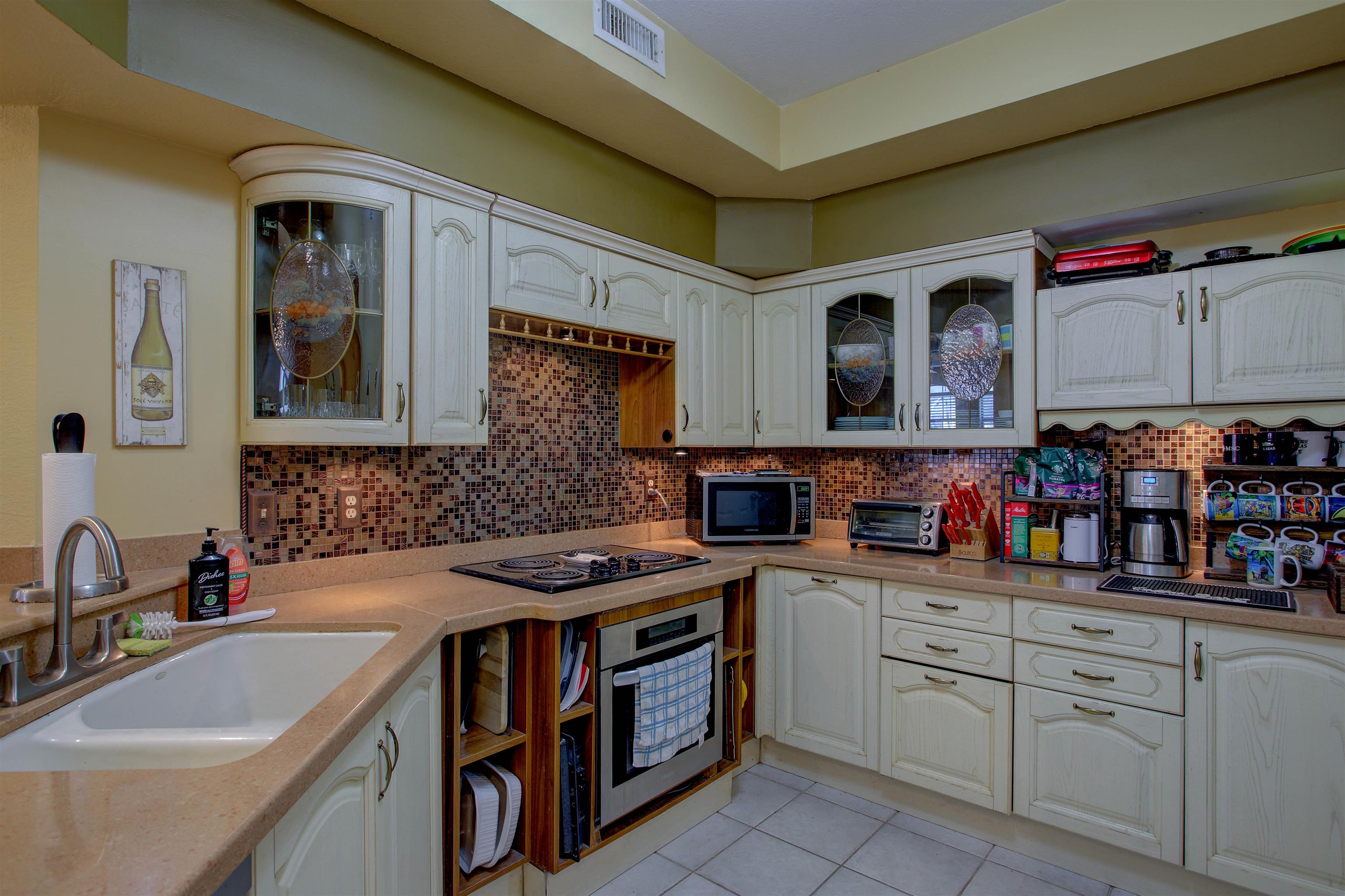 1800 Vista Cove Road St. Augustine, FL 32084 - Photo 22 of 58 a kitchen with a sink stove and cabinets