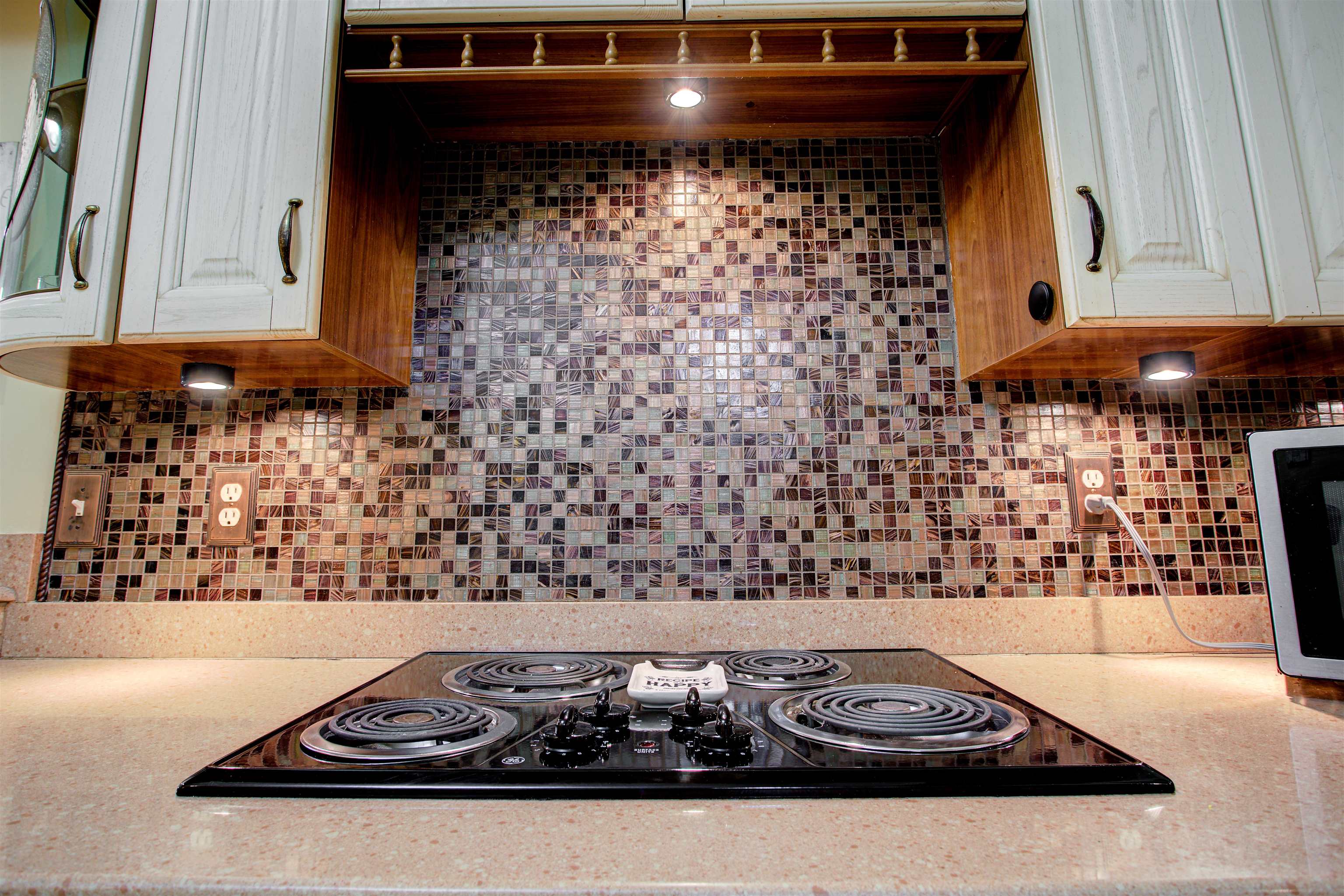 1800 Vista Cove Road St. Augustine, FL 32084 - Photo 23 of 69 Kitchen with ventilation hood, black electric stovetop, light stone countertops, and backsplash