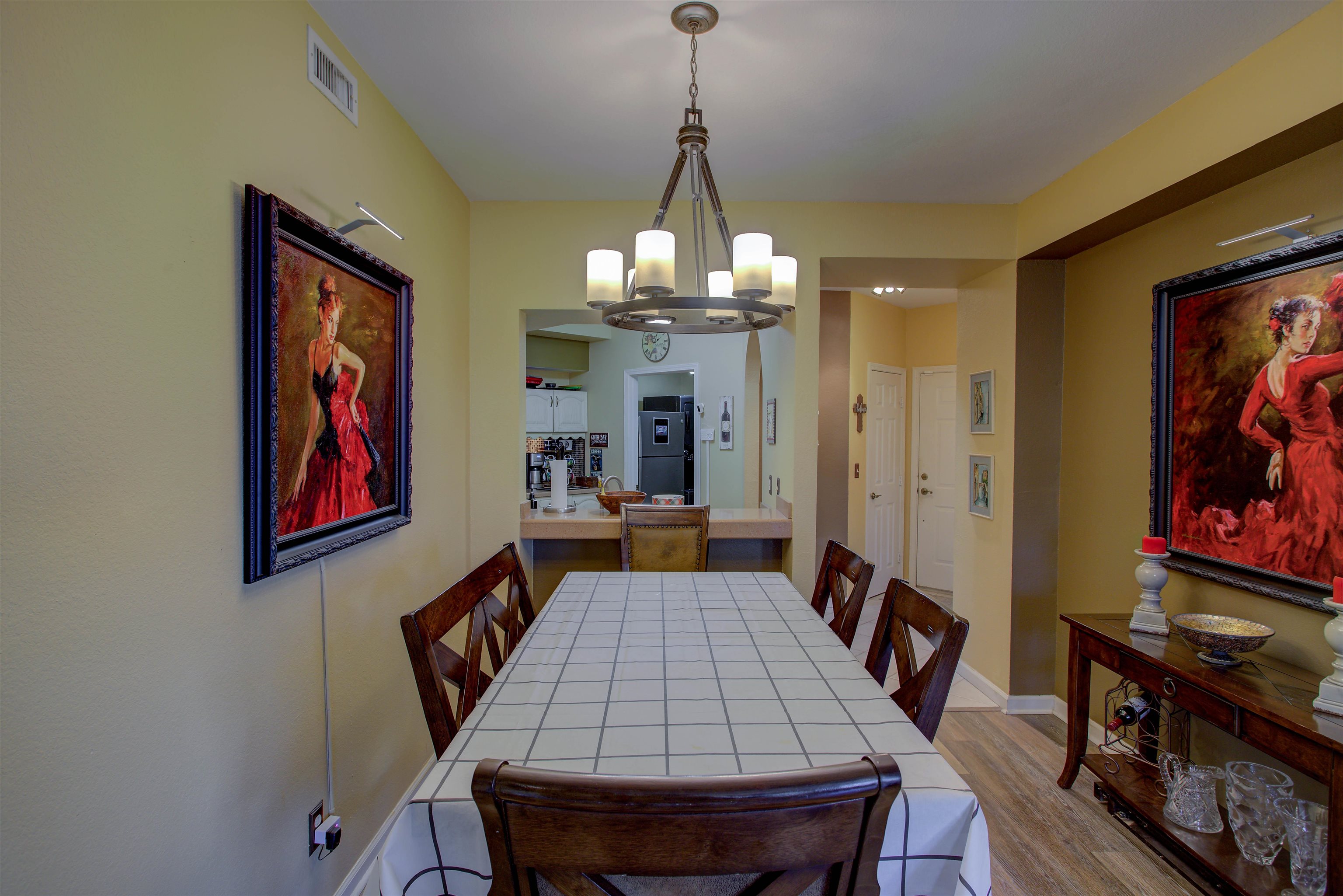 1800 Vista Cove Road St. Augustine, FL 32084 - Photo 25 of 58 a dining room with wooden floor a chandelier a wooden table and chairs