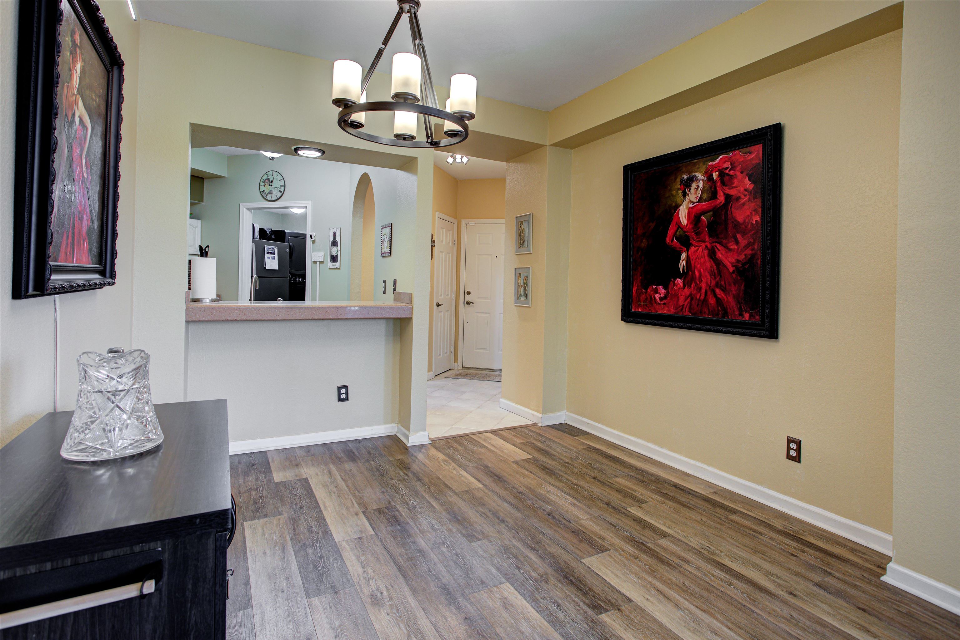 1800 Vista Cove Road St. Augustine, FL 32084 - Photo 3 of 69 Unfurnished dining area featuring arched walkways, dark wood-style floors, and suspended lighting