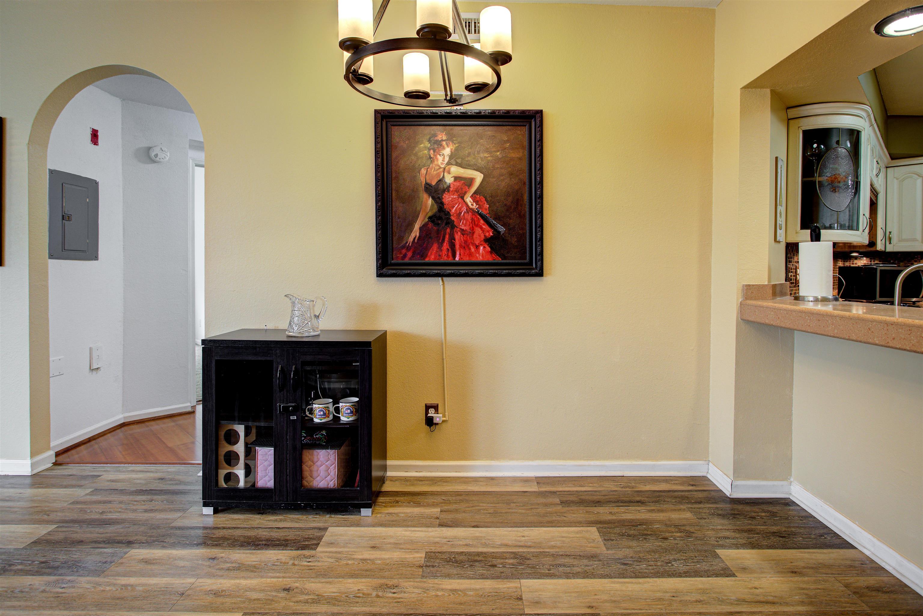 1800 Vista Cove Road St. Augustine, FL 32084 - Photo 4 of 69 Dining space with arched walkways, electric panel, wood finished floors, and a chandelier