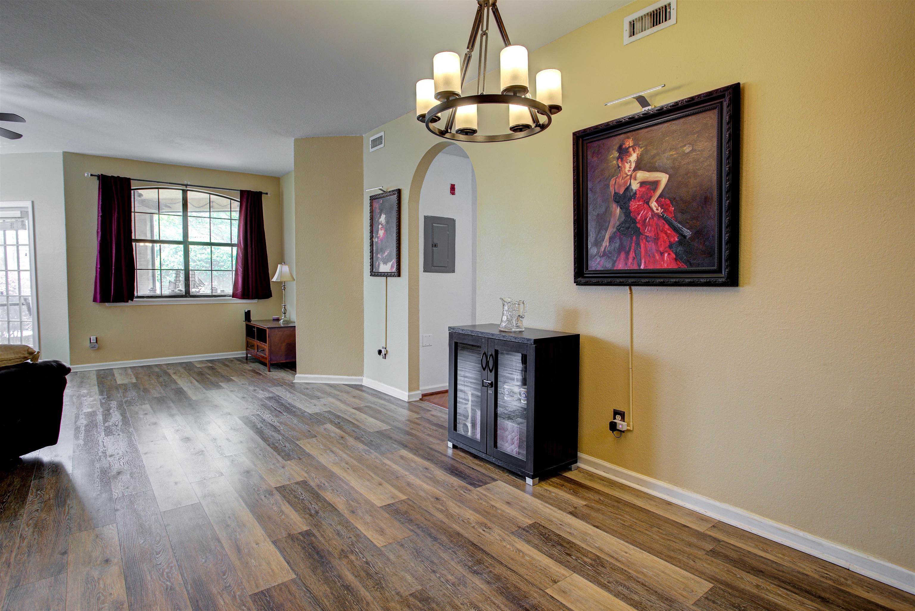 1800 Vista Cove Road St. Augustine, FL 32084 - Photo 5 of 69 Unfurnished dining area featuring arched walkways, dark wood-type flooring, electric panel, and suspended lighting
