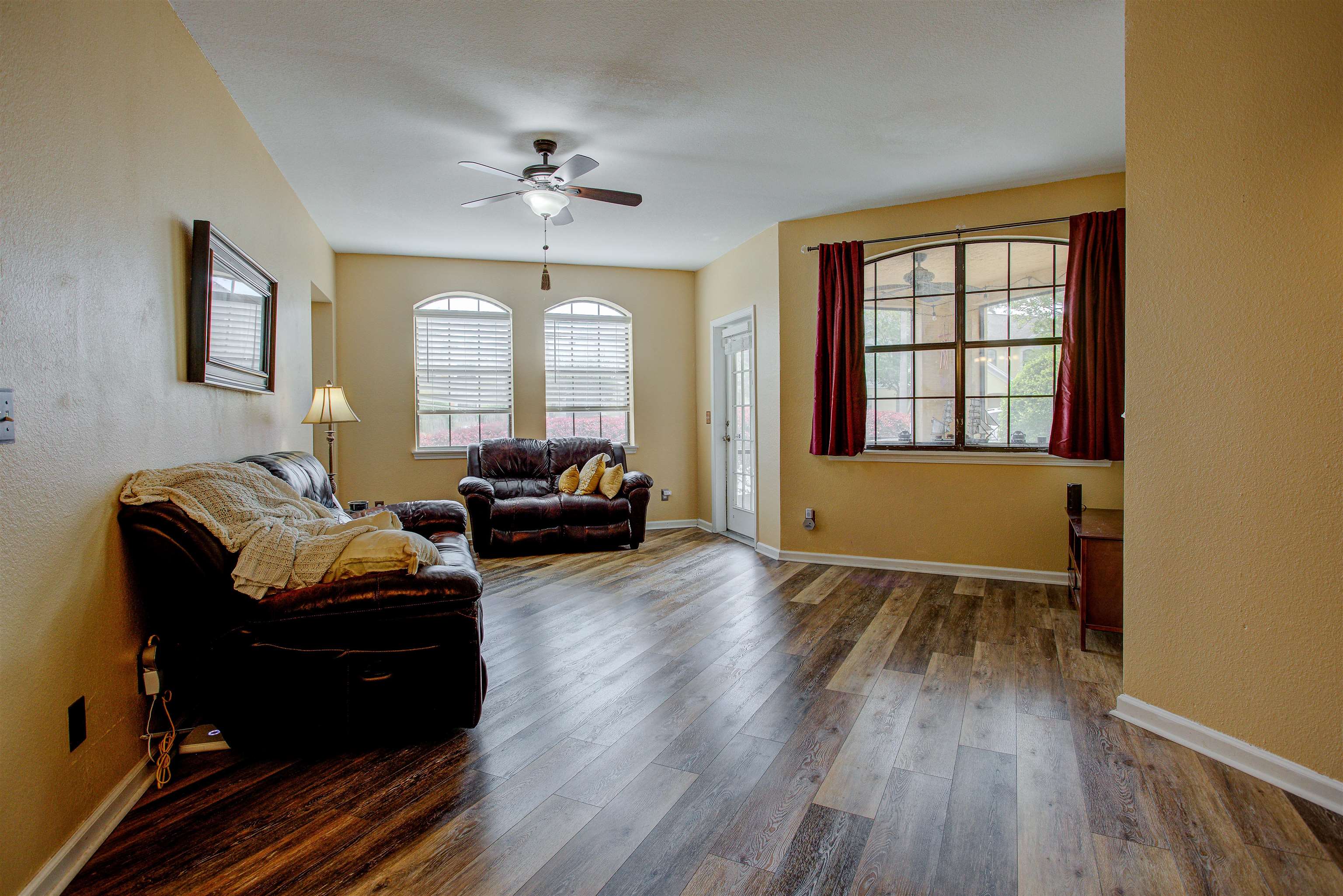 1800 Vista Cove Road St. Augustine, FL 32084 - Photo 8 of 69 Living room with dark wood finished floors, a ceiling fan, and a textured wall
