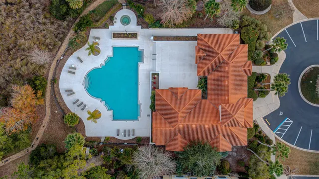 an aerial view of a house with outdoor space and swimming pool