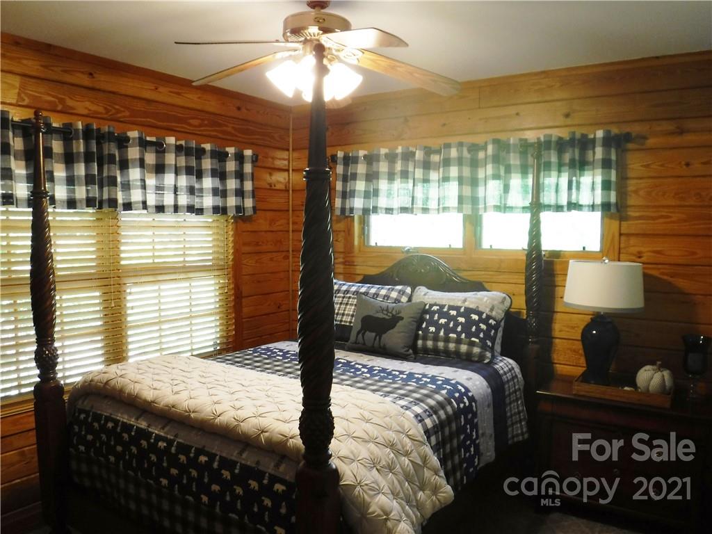 454 South Pointe Road Mill Spring, NC 28756 - Photo 14 of 47 a bedroom with a bed and wooden floor