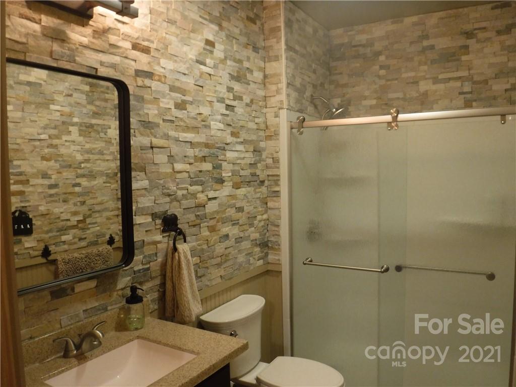 454 South Pointe Road Mill Spring, NC 28756 - Photo 22 of 47 a bathroom with a toilet and a shower