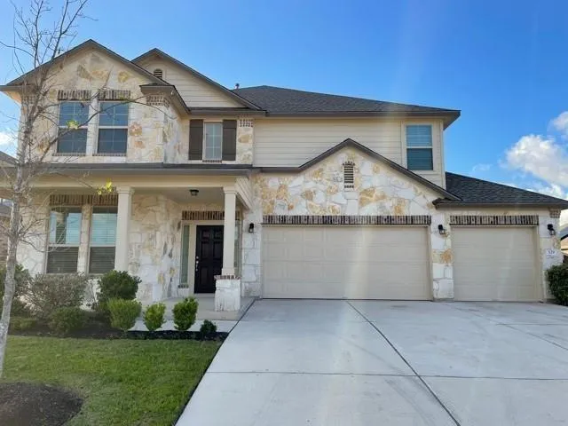 a view of a white house with a yard and plants