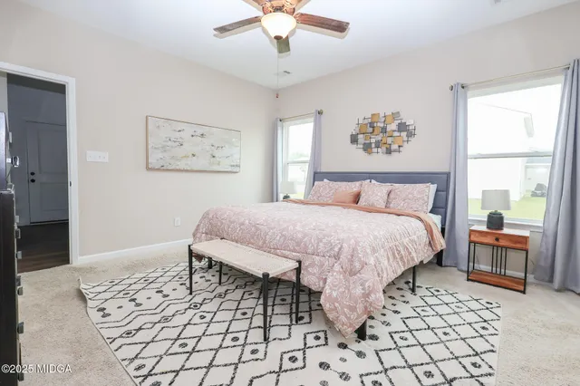 a bedroom with a bed and a painting on the wall