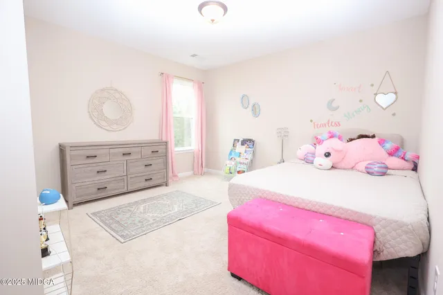 a bedroom with a bed and a dresser