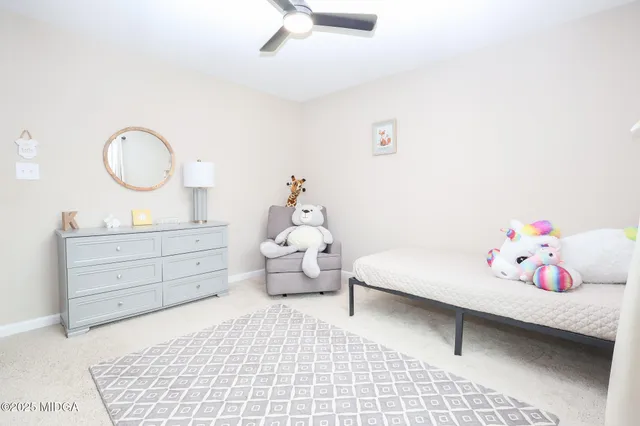 a bedroom with a bed and a baby crib