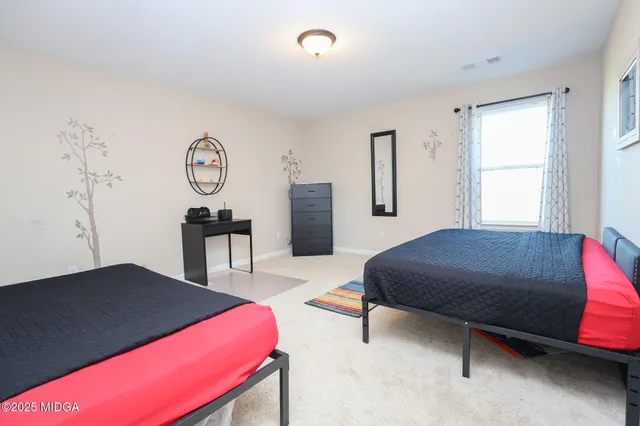 a bedroom with a bed and a table in it