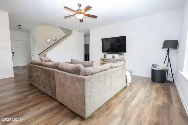 a living room with furniture and a flat screen tv