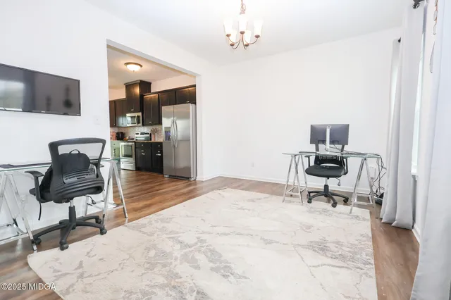 a bedroom with a bed a chair and piano