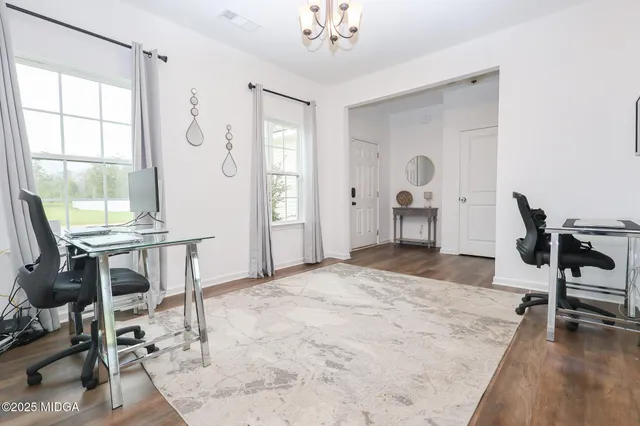 a bedroom with a bed and a table chair