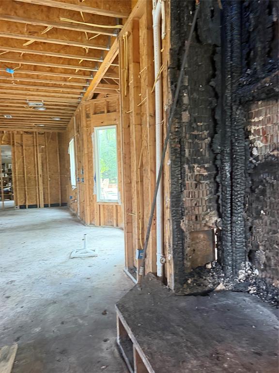 83 Bass Road Pottsboro, TX 75076 - Photo 17 of 31 Framed interior structure featuring exposed ceiling joists and wall studs, with a visible window opening