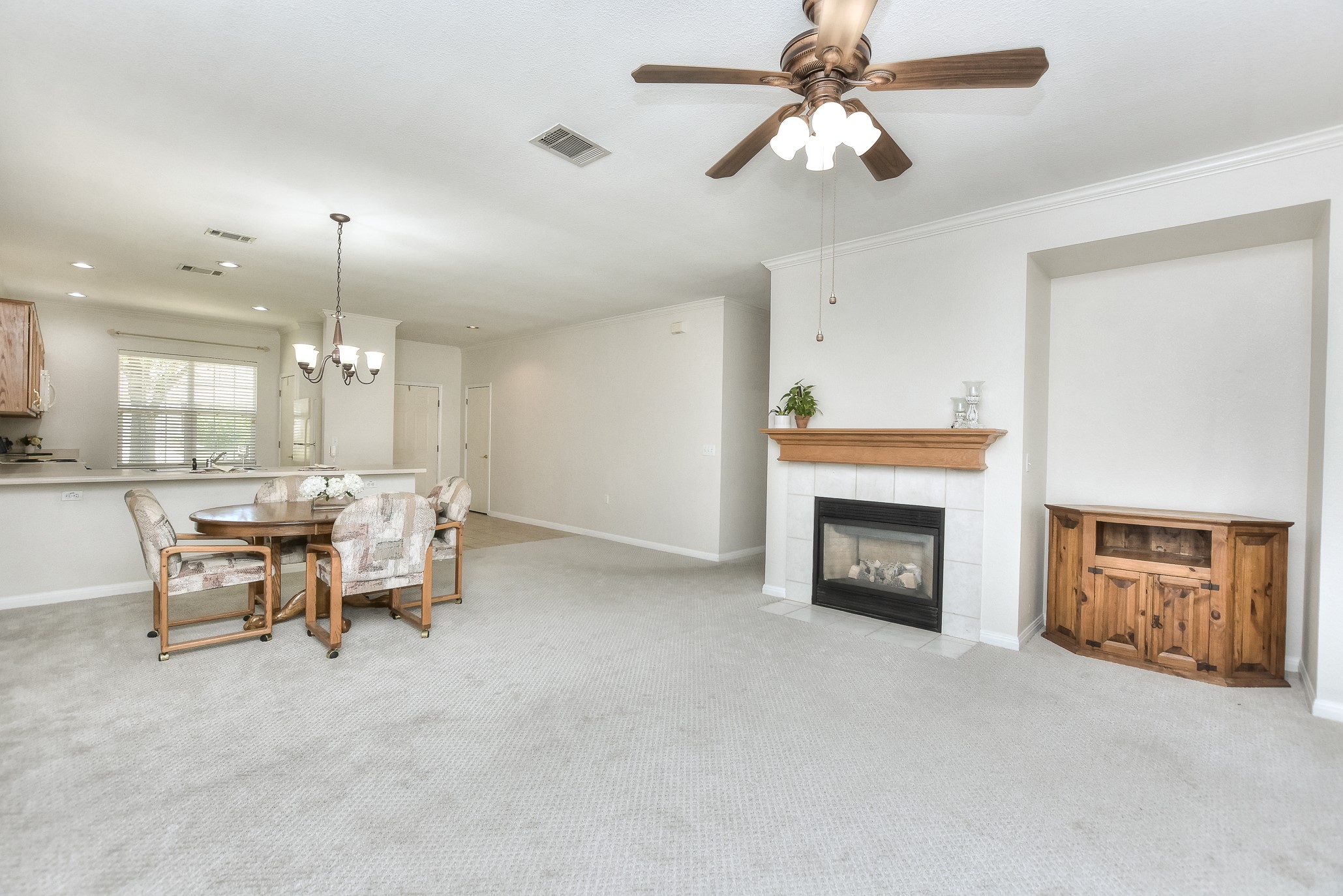 508 Texas Drive Georgetown, TX 78633 - Photo 7 of 14 A welcoming living area with a cozy fireplace and seamless transition to a dining space.