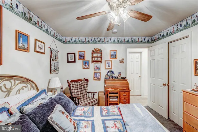 a bedroom with furniture and a ceiling fan