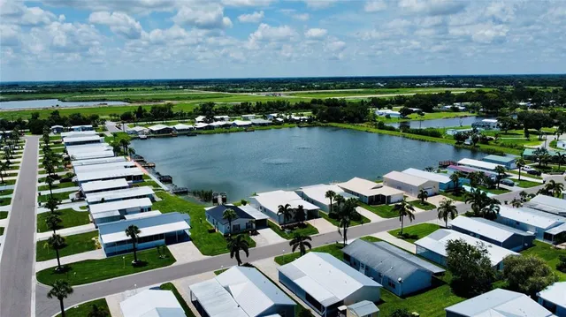 an aerial view of a house with a lake view