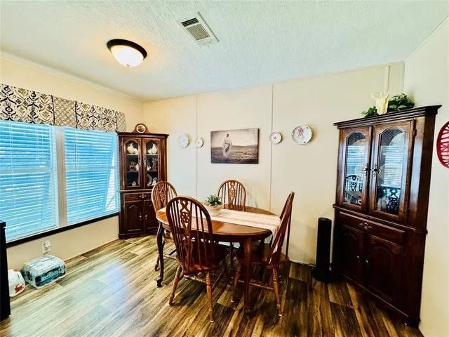 a view of a dining room with furniture and wooden floor
