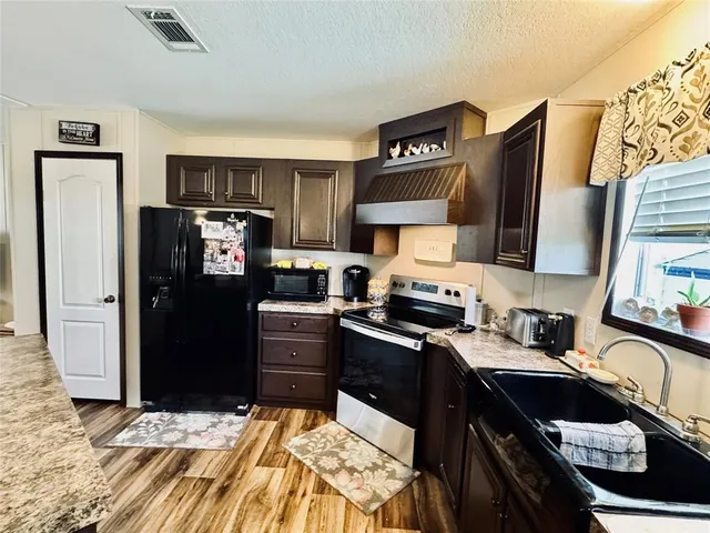 a kitchen with a refrigerator stove and sink