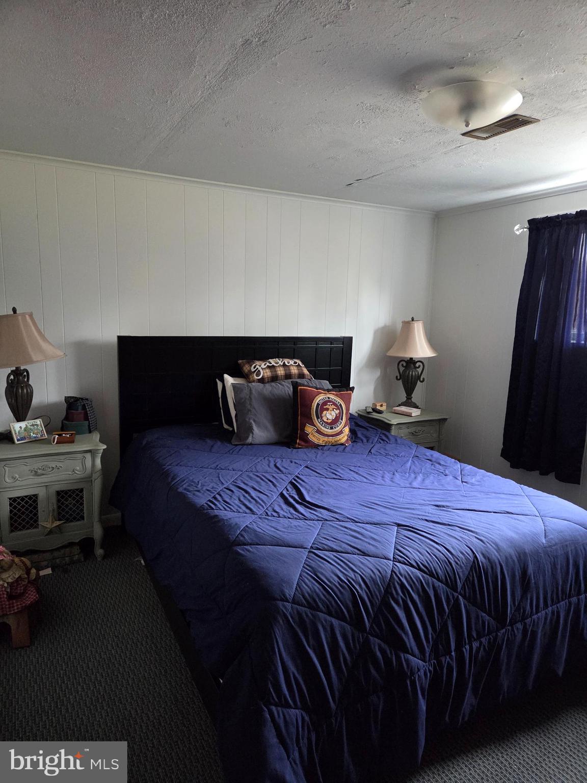 64 Rosedale Drive Bridgeton, NJ 08302 - Photo 14 of 16 a bedroom with a bed and a lamp on dresser
