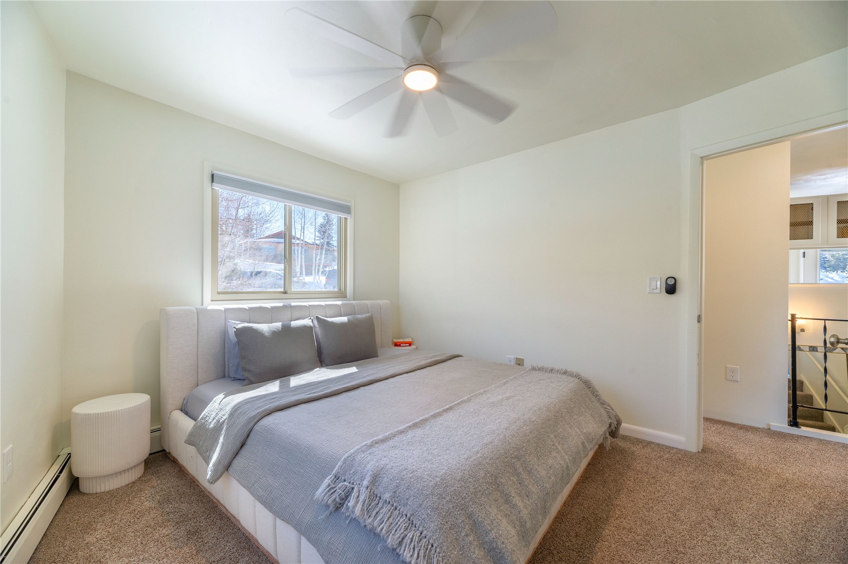 340 Buffalo Street Dillon, CO 80435 - Photo 20 of 40 a bedroom with a bed and a chandelier