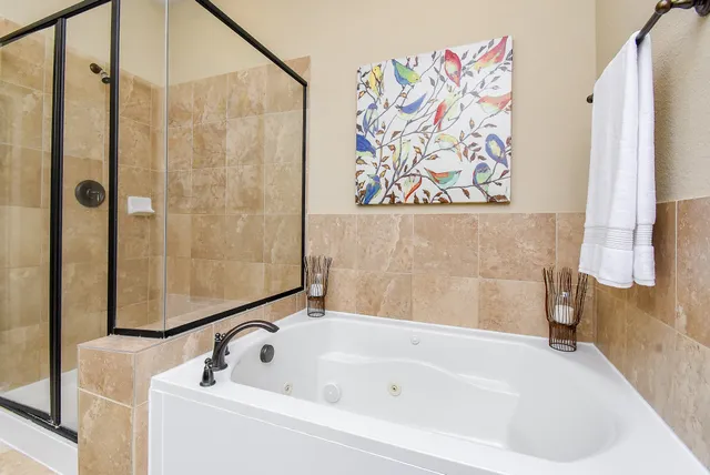 a bathroom with a bathtub and shower