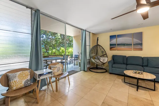 a living room with furniture and a floor to ceiling window