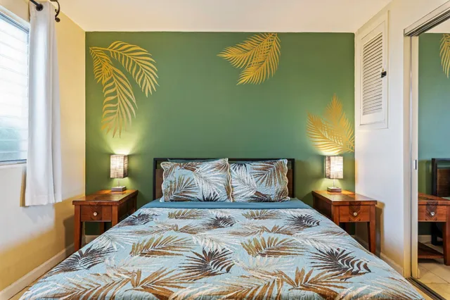 a bedroom with a bed and a painting on the wall